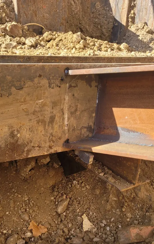 Cutting 16-inch temporary beams with precision and then welding them.
