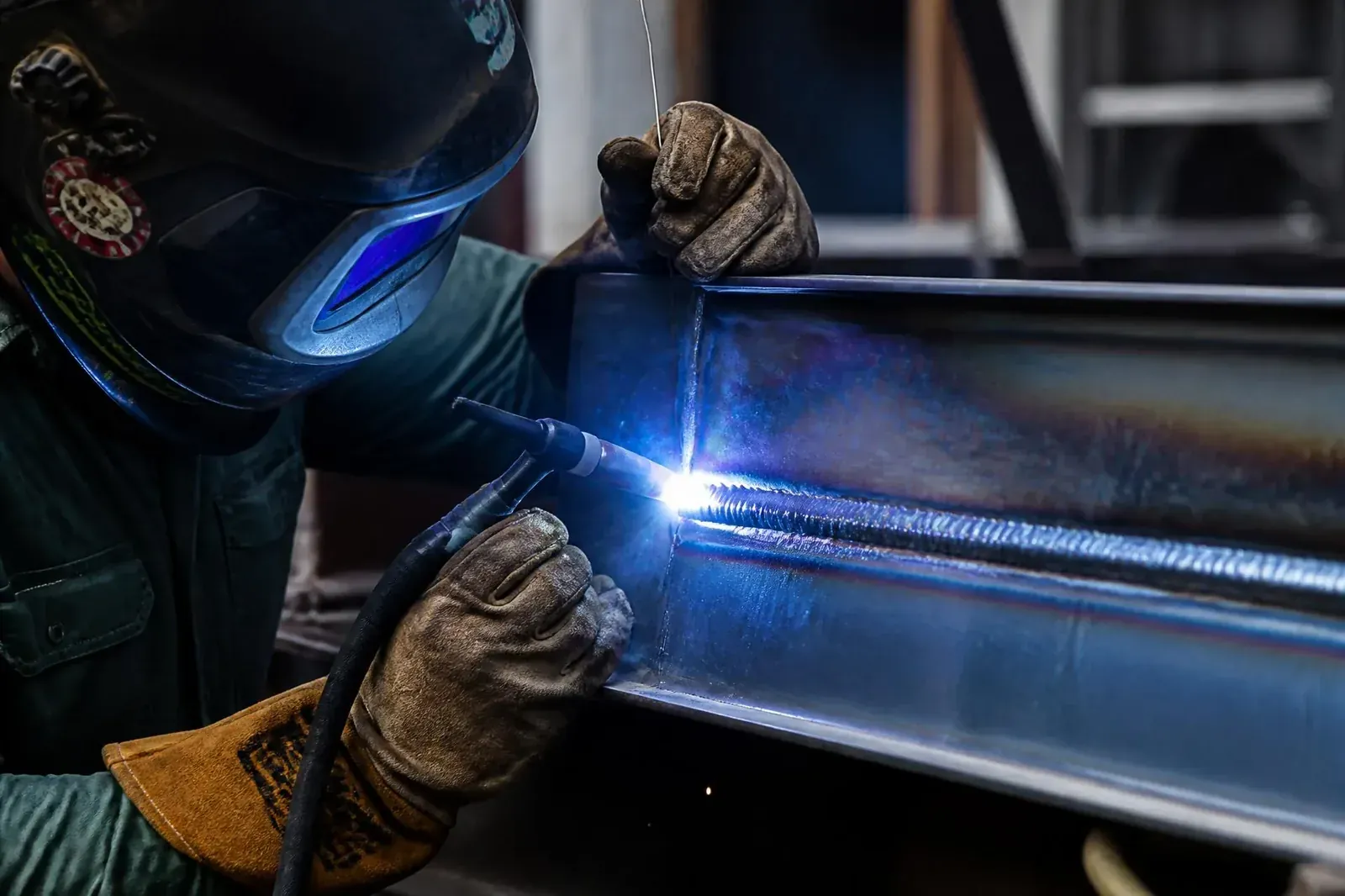 Welder at work with bright arc and sparks